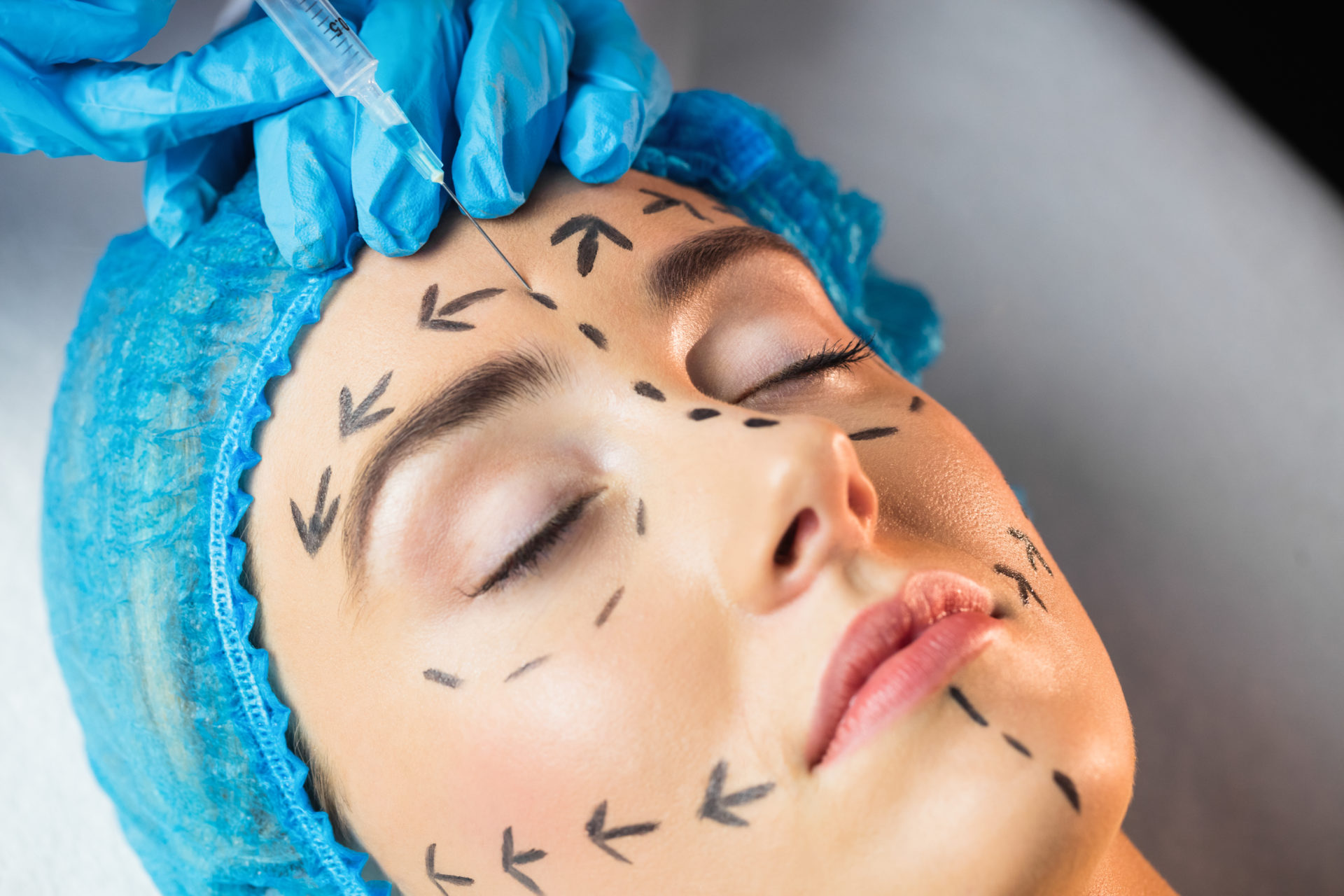 Woman receiving injection on her forehead in examination room